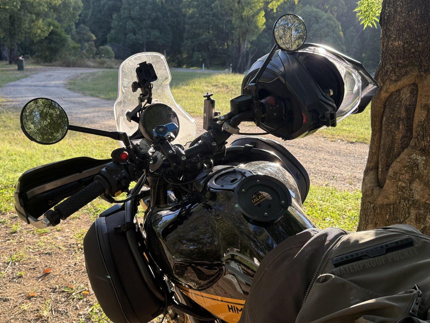 Hunter cockpit at Stacey's Bridge — windshield, helmet hanging off the bar, GoPro on the mount, tank bag still in the wrong place