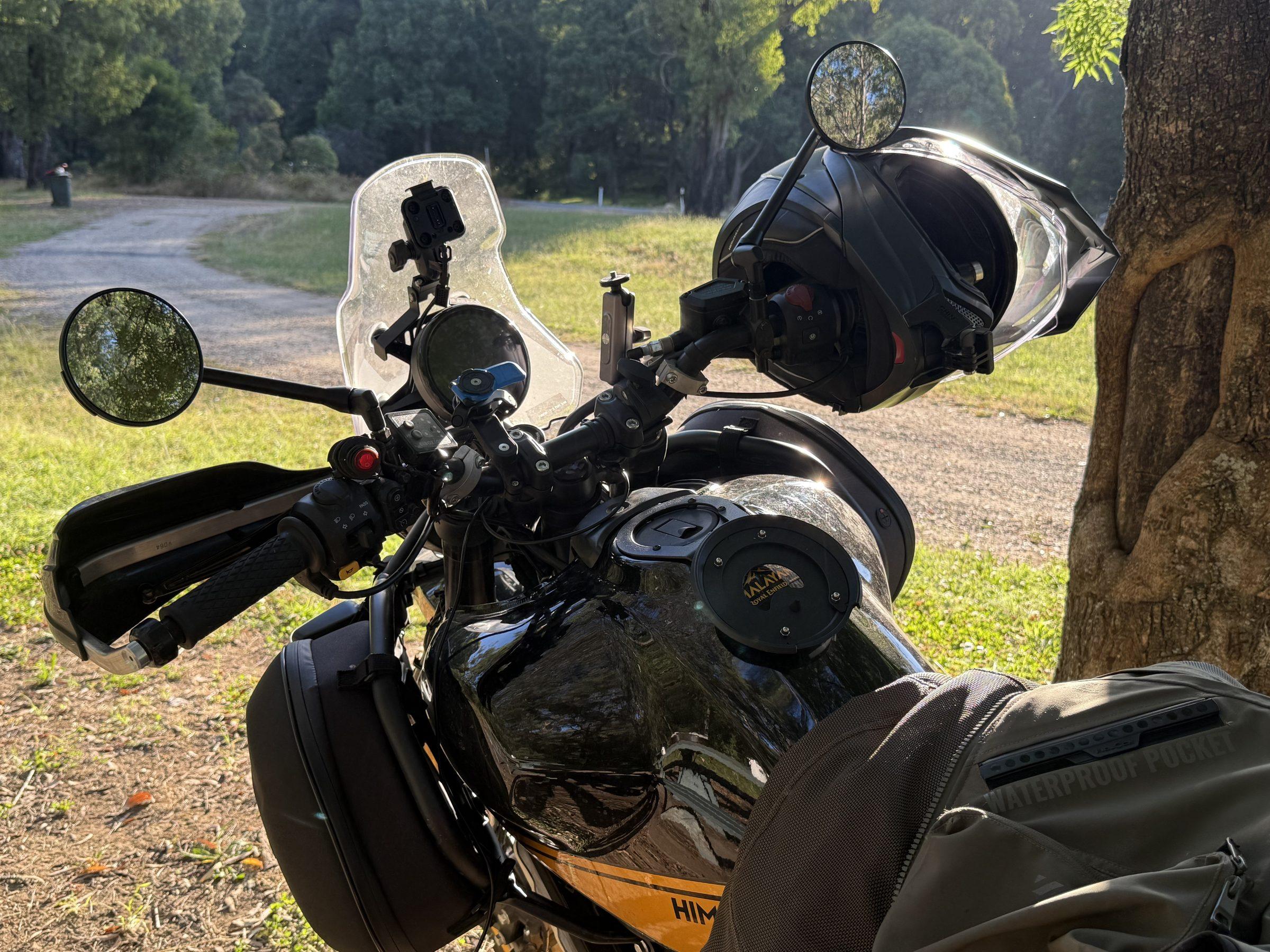 Hunter cockpit at Stacey's Bridge — windshield, helmet on the bar, tank bag, morning light