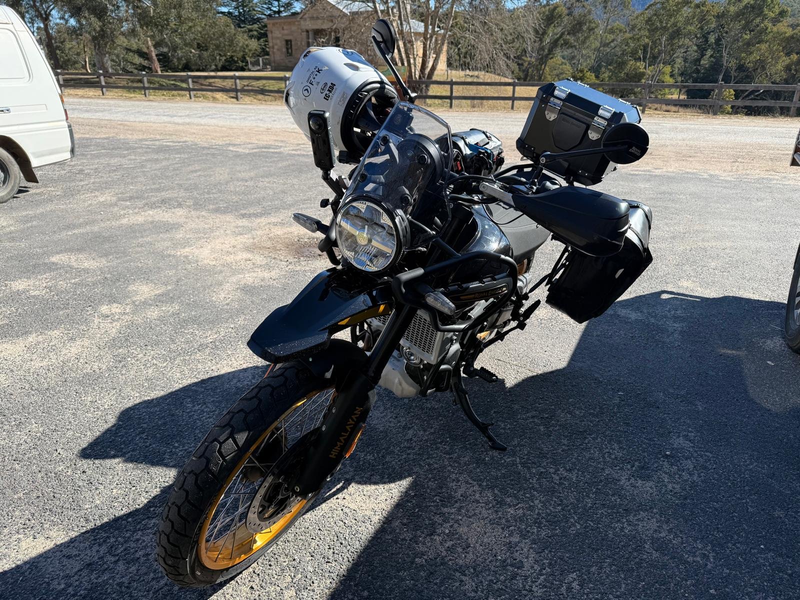 Hunter parked alone, three-quarter front, helmet on the seat — the morning before